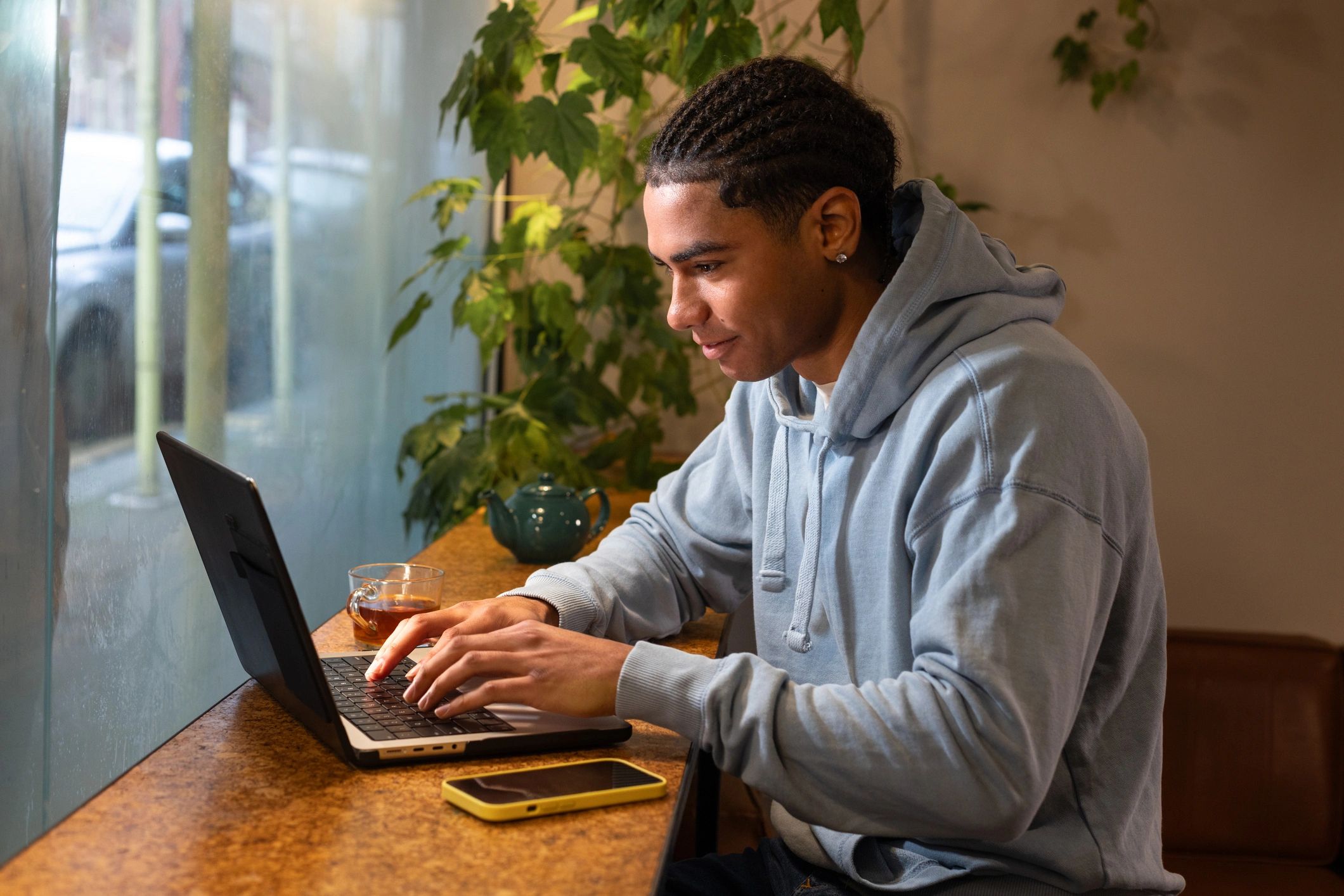 Student studying on a laptop in a cafe