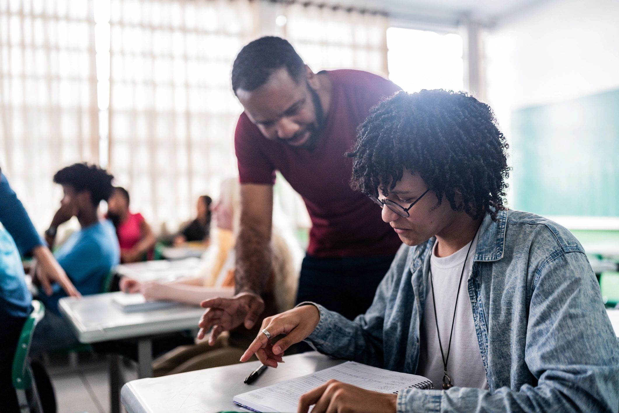 Teacher assisting a student during class
