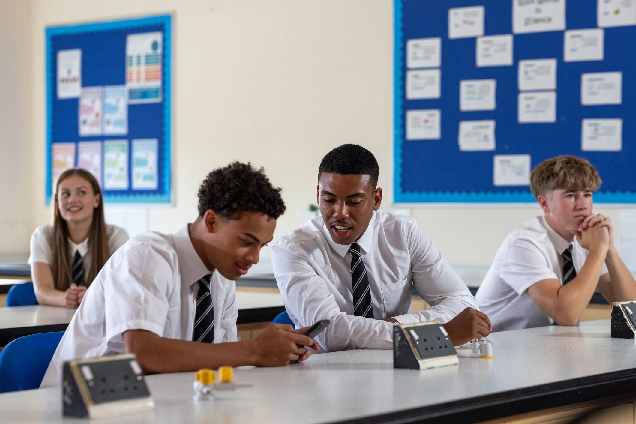 Students relaxing together in a classroom before class