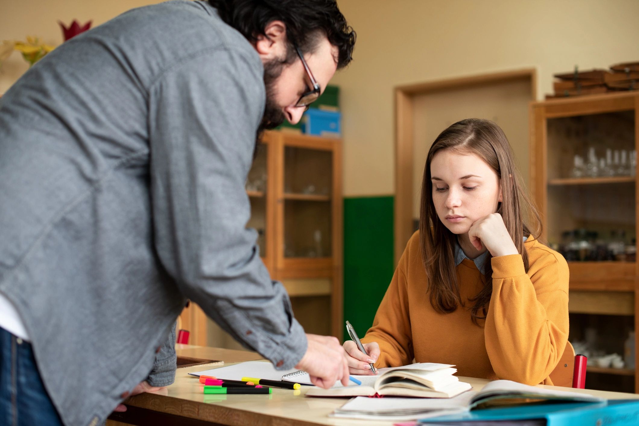 Teacher helping a student in class